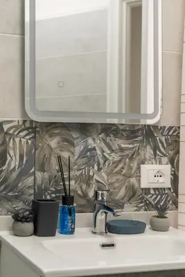 a bathroom with a sink and a mirror at Appartamento vicolo Savelli in Rome