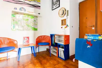 a room with two desks and a table and chairs at Appartamento con balcone a San Giovanni, piano alto con vista su Roma in Rome