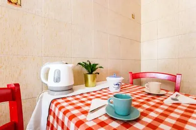 a table with a red and white checkered table cloth at Appartamento con balcone a San Giovanni, piano alto con vista su Roma in Rome