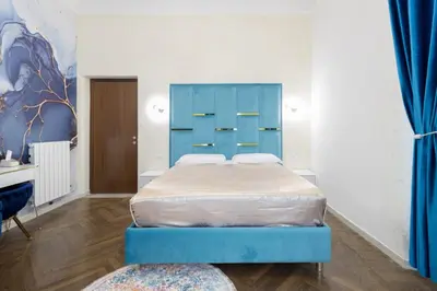 a bedroom with two beds and a blue cabinet at Just Chilling Home in Rome