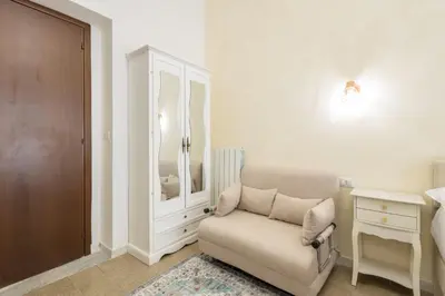 a bedroom with a chair and a dresser and a bed at Just Chilling Home in Rome