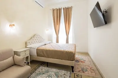 a small bedroom with a bed and a couch at Just Chilling Home in Rome