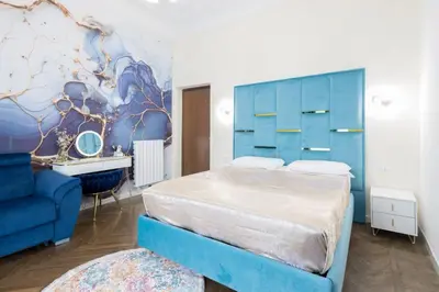 a bedroom with a blue bed and a blue couch at Just Chilling Home in Rome