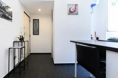 a kitchen with white walls and a black counter top at Casetta di quartiere Roma in Rome