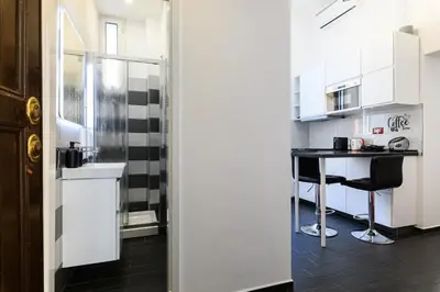 a kitchen with a counter and a table in a room at Casetta di quartiere Roma in Rome