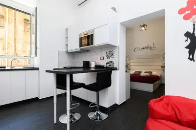 a small kitchen with a table in a room at Casetta di quartiere Roma in Rome