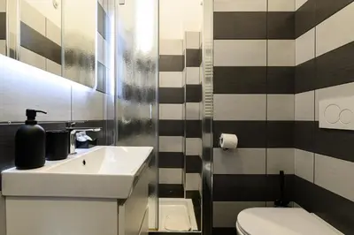 a bathroom with a sink and a toilet at Casetta di quartiere Roma in Rome