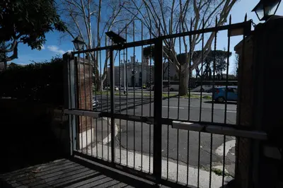an iron gate with a street behind it at Casa Mercanti in Rome
