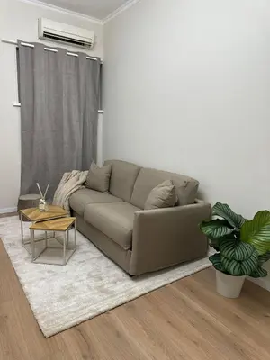 a living room with a couch and a table at JULIX - Roma Quadraro Apartment in Rome