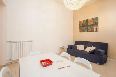 a living room with a white table and a couch at Large Apartment near Coliseum in Rome