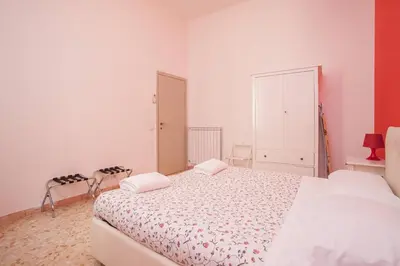 a white bedroom with a large bed in it at Large Apartment near Coliseum in Rome