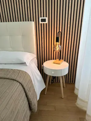 a bedroom with a bed and a table with a lamp at Green Hotel in Rome