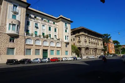 a building with cars parked on the side of a street at Green Hotel in Rome