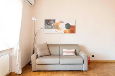 a living room with a couch and a lamp at Apartment near Vatican & Foro Italico - Rome in Rome