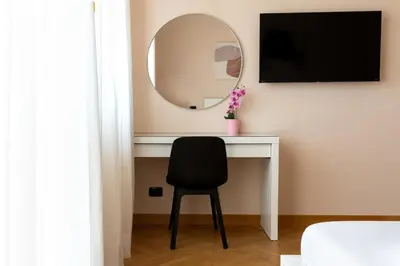 a bedroom with a white bed with two night stands at Apartment near Vatican & Foro Italico - Rome in Rome