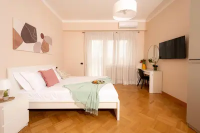 a bedroom with a white bed and two night stands at Apartment near Vatican & Foro Italico - Rome in Rome