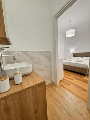 a bathroom with a tub and a sink and a bed at Lolus House in Rome