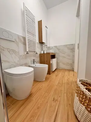 a bathroom with a white toilet and a sink at Lolus House in Rome