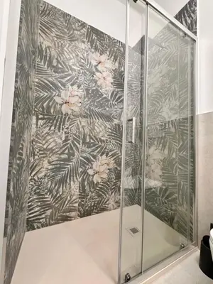 a shower in a bathroom with a floral wallpaper at Lolus House in Rome