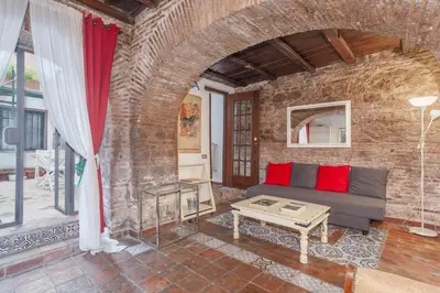 a living room with a couch and a brick wall at Il Piccolo Arco in Rome