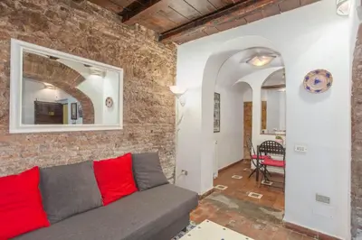 a living room with a couch and a brick wall at Il Piccolo Arco in Rome