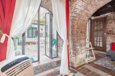 a room with a brick wall and a window at Il Piccolo Arco in Rome