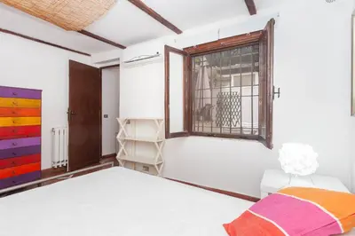 a bedroom with a bed and a window at Il Piccolo Arco in Rome