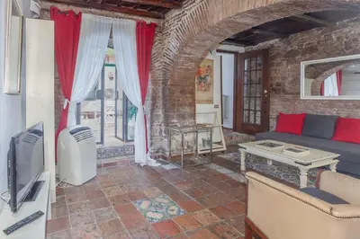 a living room with a couch and a tv at Il Piccolo Arco in Rome