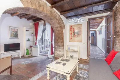 a living room with a couch and a table at Il Piccolo Arco in Rome