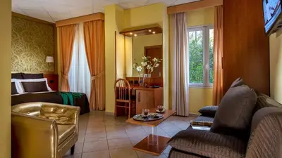 a living room with a couch and a bed and a table at IN Roma Vale&Hillary colosseo b&b in Rome