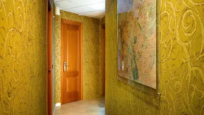 a hallway with yellow walls and a map on the wall at IN Roma Vale&Hillary colosseo b&b in Rome