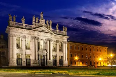 a large white building at night at IN Roma Vale&Hillary colosseo b&b in Rome