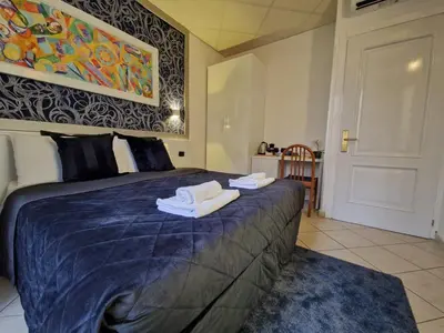 a bedroom with a bed with two towels on it at IN Roma Vale&Hillary colosseo b&b in Rome