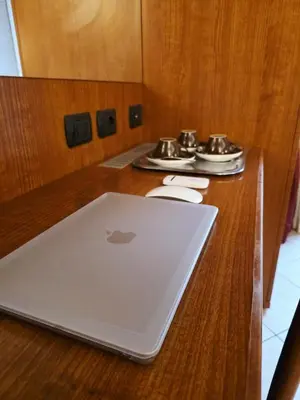 an apple laptop sitting on a wooden table at IN Roma Vale&Hillary colosseo b&b in Rome