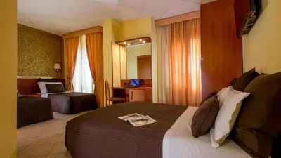a hotel room with a bed with a newspaper on it at IN Roma Vale&Hillary colosseo b&b in Rome