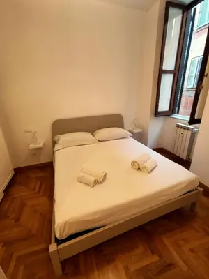 a bedroom with a bed with two towels on it at Residenza Coronari in Rome