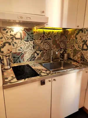 a kitchen with a sink and a colorful wall at Residenza Coronari in Rome