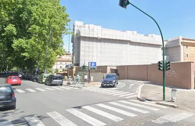 an intersection with cars on a city street with a traffic light at Residenza Coronari in Rome