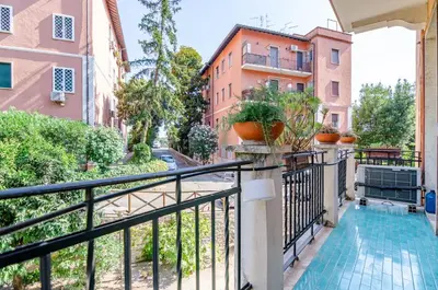 a balcony with a pool and buildings at Hot Tub - Private Parking - park in Rome