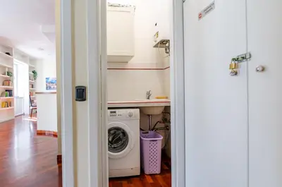 a laundry room with a washer and dryer in it at Hot Tub - Private Parking - park in Rome