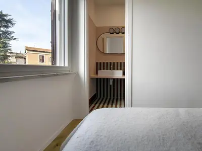 a bedroom with a bed and a window at La Garbatella dei Cesaroni in Rome