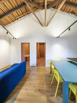 a room with a blue table and yellow chairs at La Garbatella dei Cesaroni in Rome