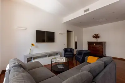 a living room with a couch and a tv at Casa Sacchi by Hili in Rome