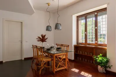 a dining room with a glass table and chairs at Casa Sacchi by Hili in Rome