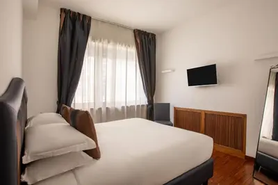 a hotel room with a bed and a television at Casa Sacchi by Hili in Rome