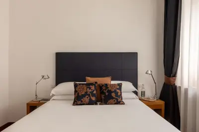 a bedroom with a white bed with two pillows at Casa Sacchi by Hili in Rome
