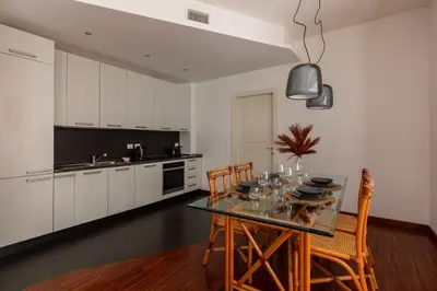 a kitchen with a dining room table and chairs at Casa Sacchi by Hili in Rome
