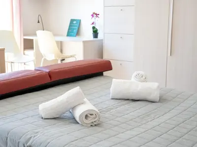 a bedroom with a bed with towels on it at Furio Camillo, Roma Centro in Rome