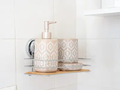 a bathroom shelf with two cups and a soap dispenser at Furio Camillo, Roma Centro in Rome