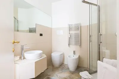 a bathroom with a toilet and a sink and a shower at Relais Calamatta in Rome